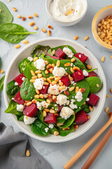 A salad with spinach, feta cheese, and nuts