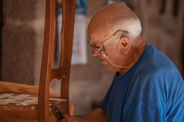 upholsterer craftsman working in the workshop