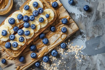Healthy summer breakfast with buckwheat bread peanut butter banana and blueberry on a wooden board Top view Flat lay