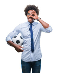 Afro american manager man holding soccer ball over isolated background with happy face smiling doing ok sign with hand on eye looking through fingers