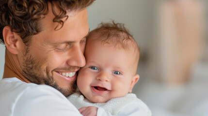 happy father is holding his smiling baby