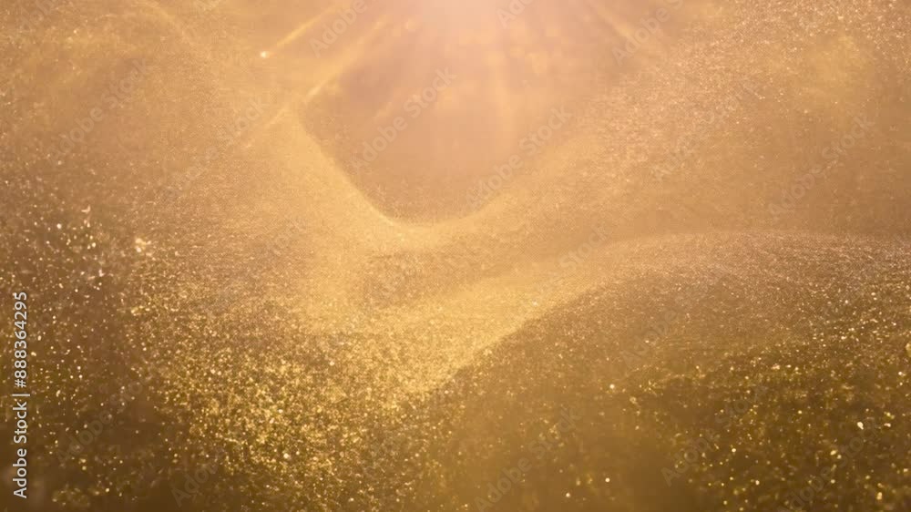 Poster Abstract background with a swirling pattern of golden glitter.