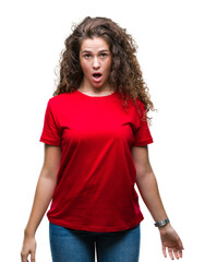 Beautiful brunette curly hair young girl wearing casual look over isolated background afraid and shocked with surprise expression, fear and excited face.