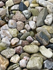 stones of different colors and sizes on the ground, stone background