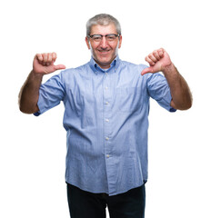 Fototapeta premium Handsome senior man wearing glasses over isolated background looking confident with smile on face, pointing oneself with fingers proud and happy.