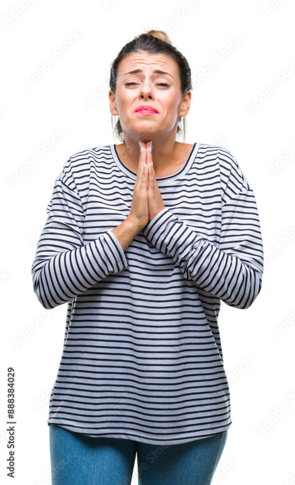 Poster Young beautiful woman casual stripes sweater over isolated background begging and praying with hands together with hope expression on face very emotional and worried. Asking for forgiveness.