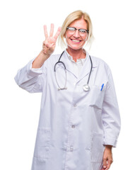 Middle age blonde doctor woman over isolated background showing and pointing up with fingers number three while smiling confident and happy.