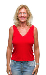 Fototapeta premium Middle age blonde woman over isolated background with a happy and cool smile on face. Lucky person.