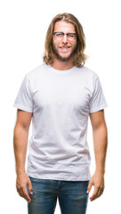Young handsome man with long hair wearing glasses over isolated background winking looking at the...