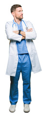 Handsome doctor man wearing medical uniform over isolated background smiling looking to the side with arms crossed convinced and confident