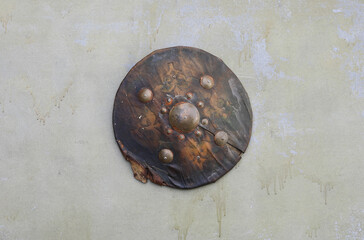 ancient leather round shield on old background