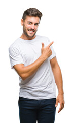 Young handsome man over isolated background cheerful with a smile of face pointing with hand and...