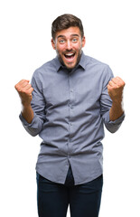 Young handsome man over isolated background celebrating surprised and amazed for success with arms raised and open eyes. Winner concept.