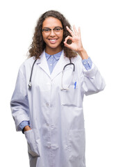 Young hispanic doctor woman doing ok sign with fingers, excellent symbol