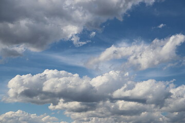 Blue sky with white fluffy clouds. Nature background. Space for text. Abstract background.