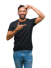 Adult hispanic man over isolated background smiling making frame with hands and fingers with happy face. Creativity and photography concept.