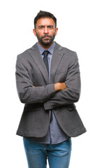 Fototapeta premium Adult hispanic business man over isolated background skeptic and nervous, disapproving expression on face with crossed arms. Negative person.