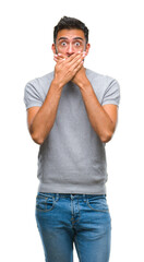 Fototapeta premium Adult hispanic man over isolated background shocked covering mouth with hands for mistake. Secret concept.