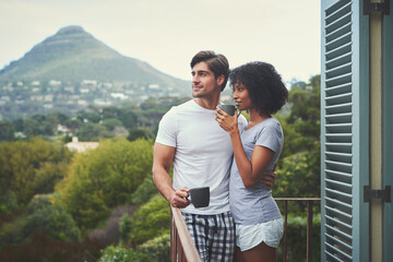 Couple, tea and relax on balcony in home for bonding, morning drink for wellness on vacation. Black woman, man and together with coffee in house on holiday, holding hands for relationship in Portugal
