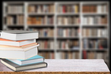 stack of books in library on wooden table