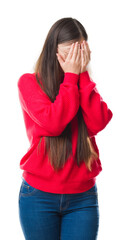 Young Chinese woman over isolated background wearing glasses with sad expression covering face with hands while crying. Depression concept.