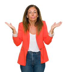Beautiful middle age business adult woman over isolated background clueless and confused expression...