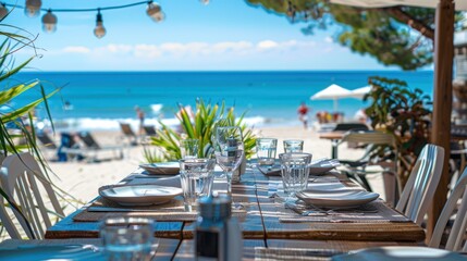 Obraz premium Beachfront Dining. Table set for lunch with an ocean view. Perfect for travel, restaurant, and vacation themes.