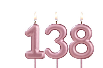 Candle number 138 - Lit birthday candle on white background