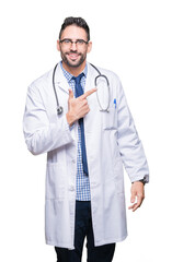 Handsome young doctor man over isolated background cheerful with a smile of face pointing with hand and finger up to the side with happy and natural expression on face