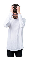 Young handsome man wearing sunglasses over isolated background suffering from headache desperate and stressed because pain and migraine. Hands on head.
