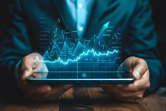 Business man holding a digital tablet to analyze the stock market graphs and charts