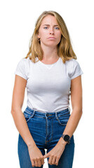 Obraz premium Beautiful young woman wearing casual white t-shirt over isolated background skeptic and nervous, frowning upset because of problem. Negative person.