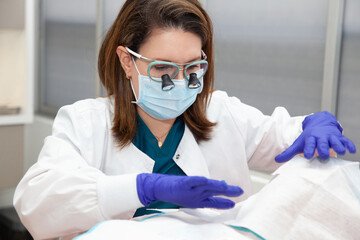 Dermatologist carrying out a skin biopsy on the face of a senior adult patient