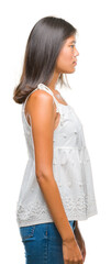 Young asian woman over isolated background looking to side, relax profile pose with natural face with confident smile.