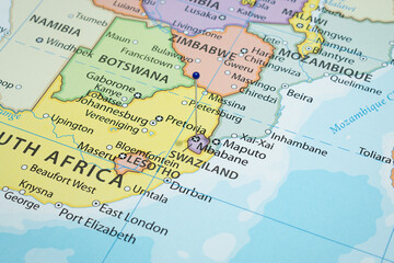 Close up to a Mbabane city with a blue pin needle into Eswatini country political map 