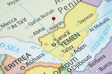 Close up to a Sanaa city with a red pin needle into Yemen country political map 