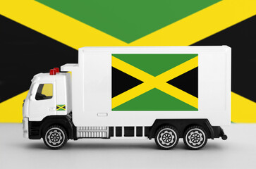 Jamaica flag depicted on side wall of white delivery van close up. Shipping and local delivery concept