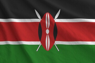 Kenya flag depicted on folded wavy fabric of old cloth close up