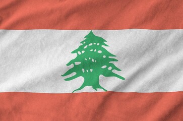 Lebanon flag depicted on folded wavy fabric of old cloth close up