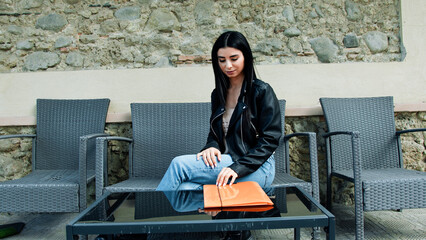 Woman Opening An Orange Folder 