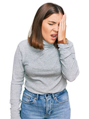 Fototapeta premium Young beautiful woman wearing casual turtleneck sweater yawning tired covering half face, eye and mouth with hand. face hurts in pain.