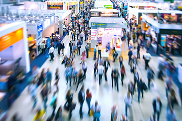 A busy shopping mall with people walking around and carrying bags