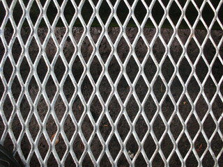 Close-Up of Industrial Metal Fence: Geometric Diamond Pattern