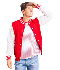 Young handsome man wearing baseball uniform smiling confident touching hair with hand up gesture, posing attractive and fashionable