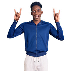Young african american man wearing sportswear shouting with crazy expression doing rock symbol with...
