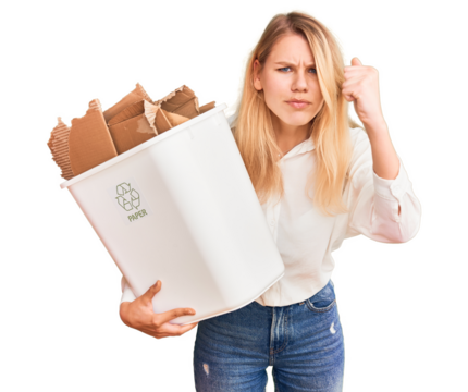Young beautiful blonde woman holding recycle paper bin annoyed and frustrated shouting with anger, yelling crazy with anger and hand raised