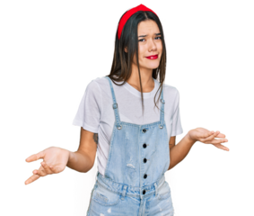Young hispanic girl wearing casual clothes clueless and confused expression with arms and hands raised. doubt concept.