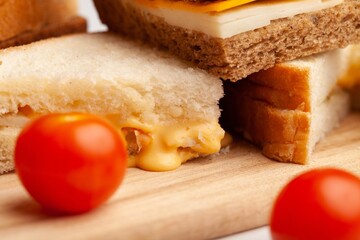 Fresh tasty sandwiches with vegetable on wooden chopping board