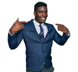 Handsome business black man wearing business suit and tie smiling cheerful showing and pointing with fingers teeth and mouth. dental health concept.