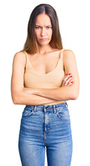 Fototapeta premium Beautiful brunette young woman wearing casual clothes skeptic and nervous, disapproving expression on face with crossed arms. negative person.